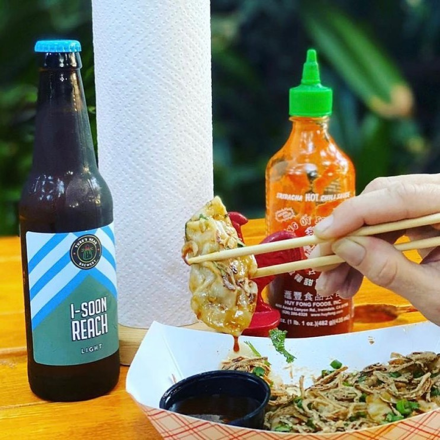 Cocovan Airstream Lounge in Turks and Caicos Eating Gyzo at Picnic Table at Cocovan Airstream Lounge in Turks and Caicos